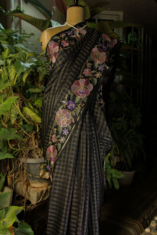 Saree with floral patterns on a mannequin against a natural background
